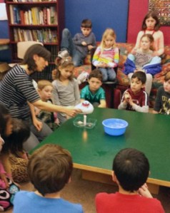 Mia Katz demonstrates a science concept to the LEAP kids.